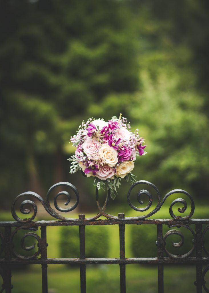 Wedding flowers on iron gate in Loch Ness Country House Hotel gardens
