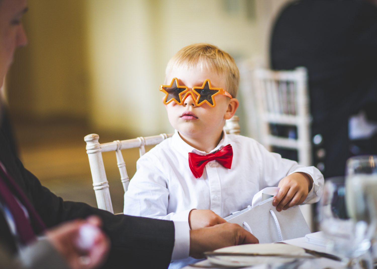 Child with start glasses and bow tie