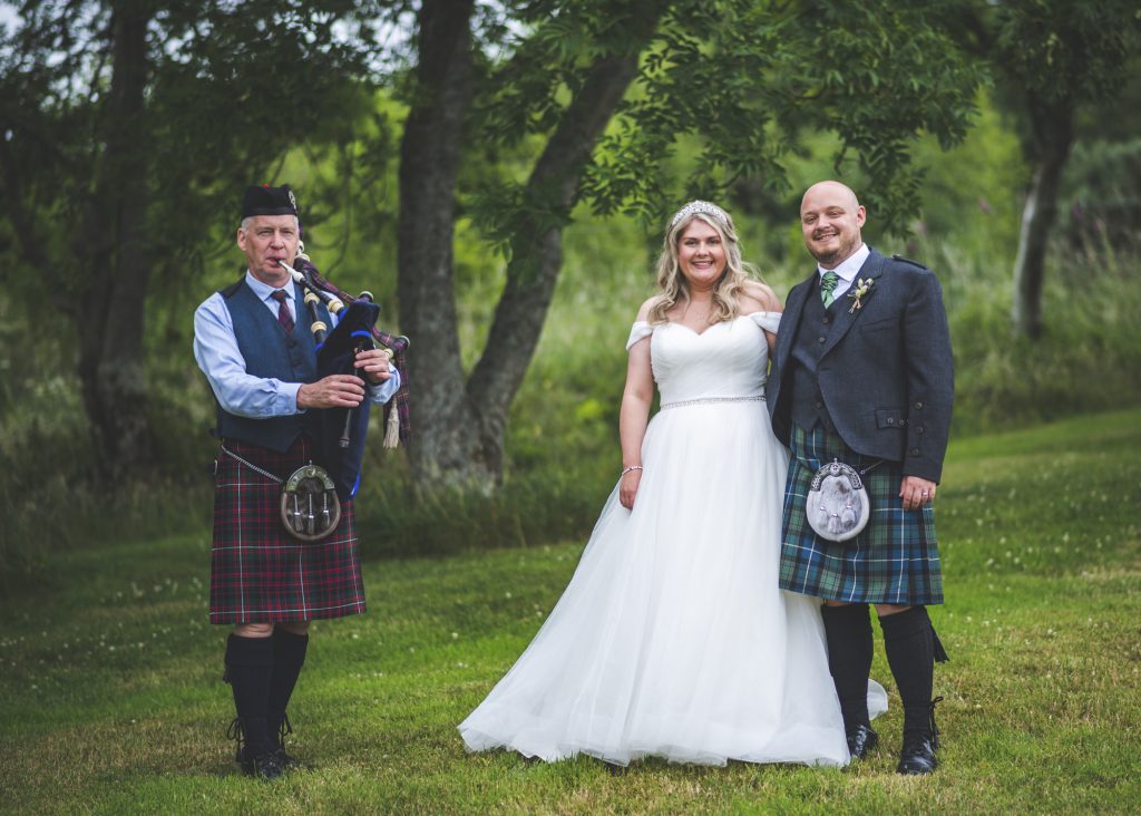 Married couple along with bagpiper
