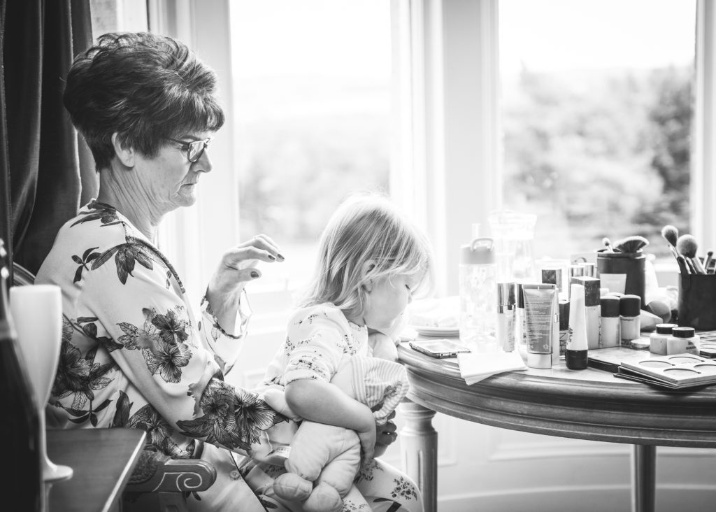Grandmother and child during preparations at Loch Ness Country House Hotel wedding