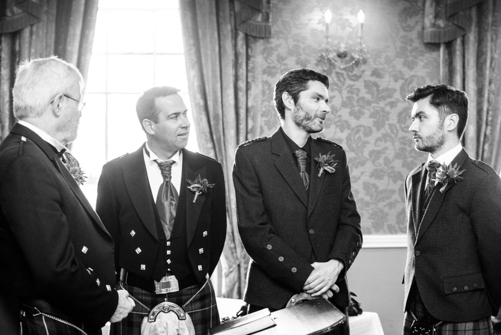 Groom, Best Man and Usher look on awaiting the bride's arrival