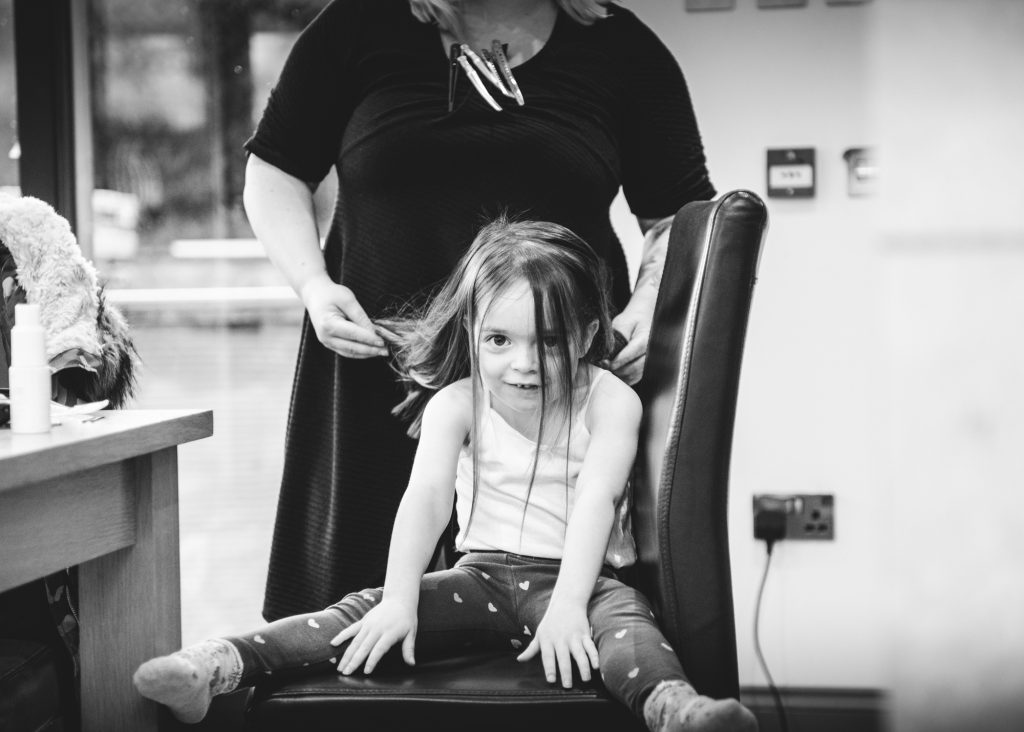 Wee girl getting her hair done for the wedding at Eilean Donan Castle