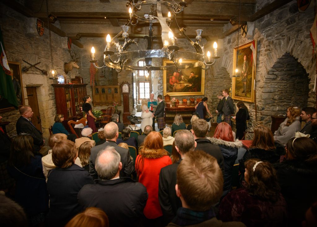 Wedding guests gather in the Banqueting Hall for an Eilean Donan Castle wedding ceremony