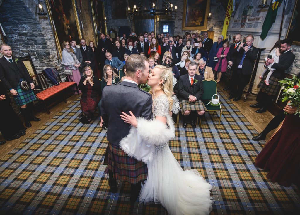 Couple's first kiss in front of their wedding guests