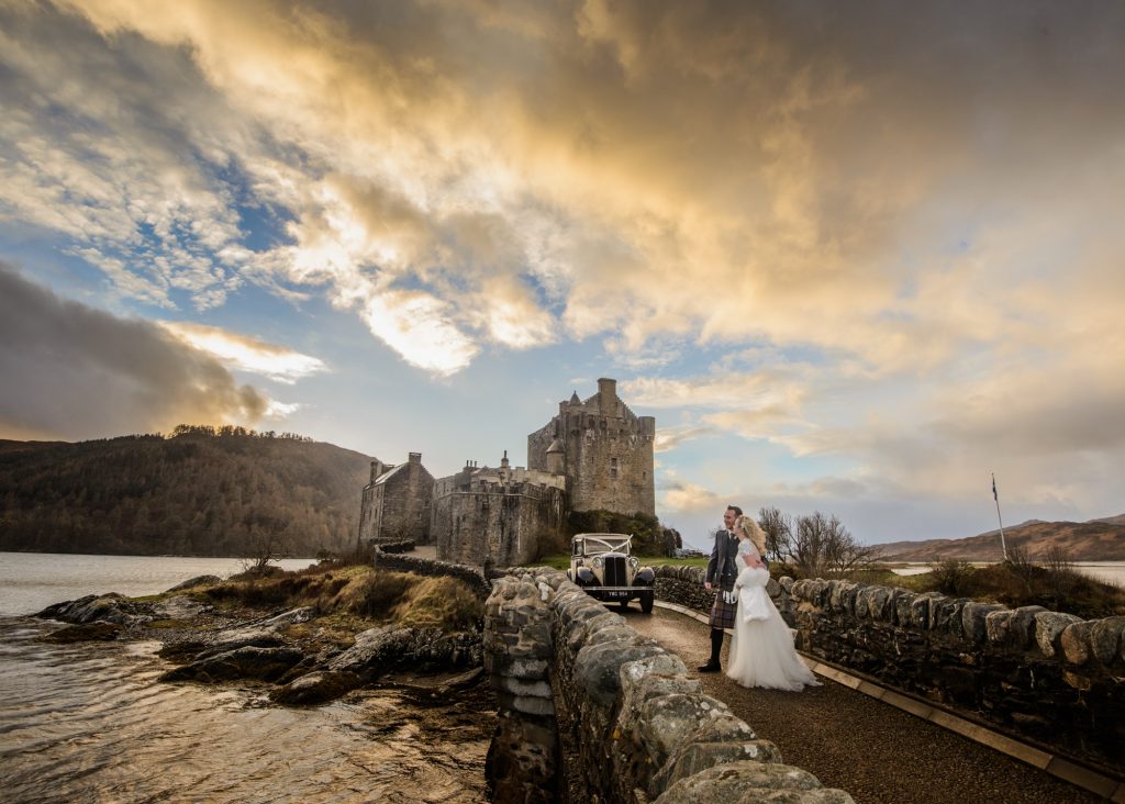 Bride and groom on the bridge at Eilean Donan Castle