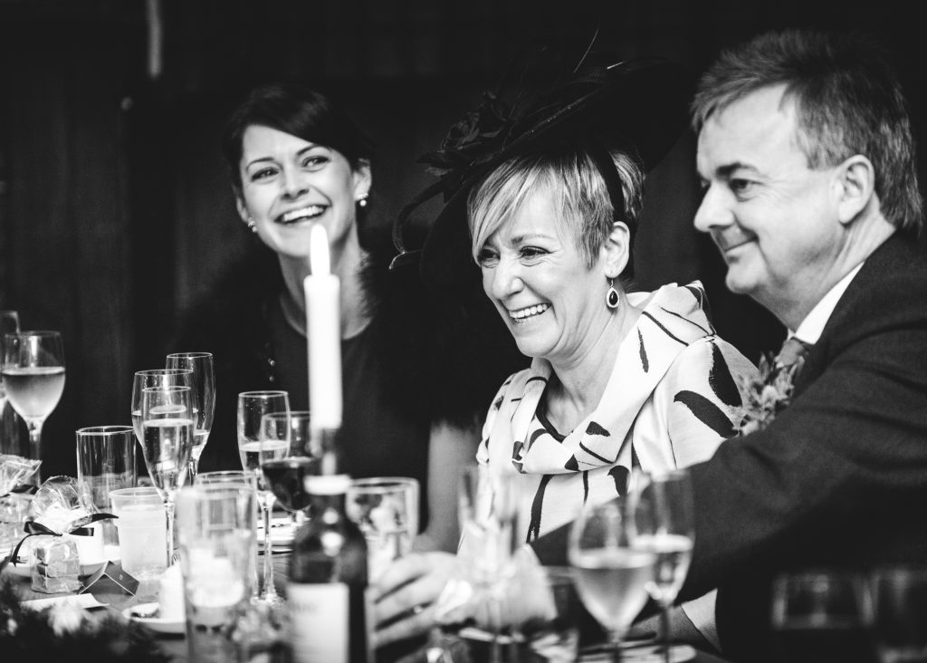 Mother of the bride laughing at speeches jokes