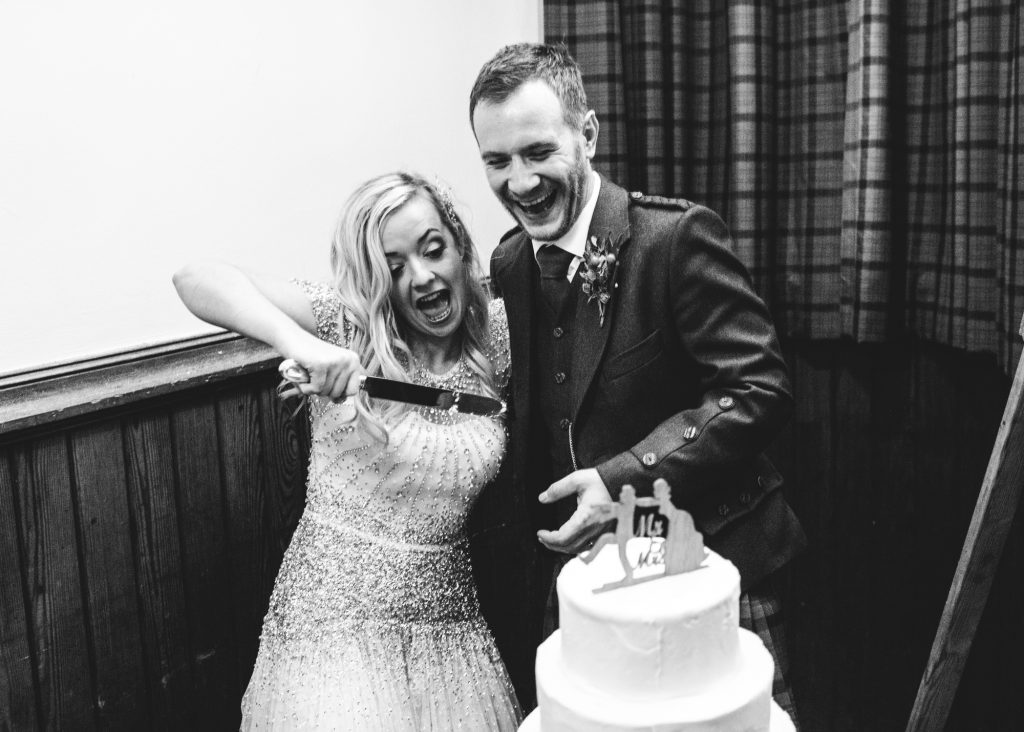 Couple cutting their wedding cake