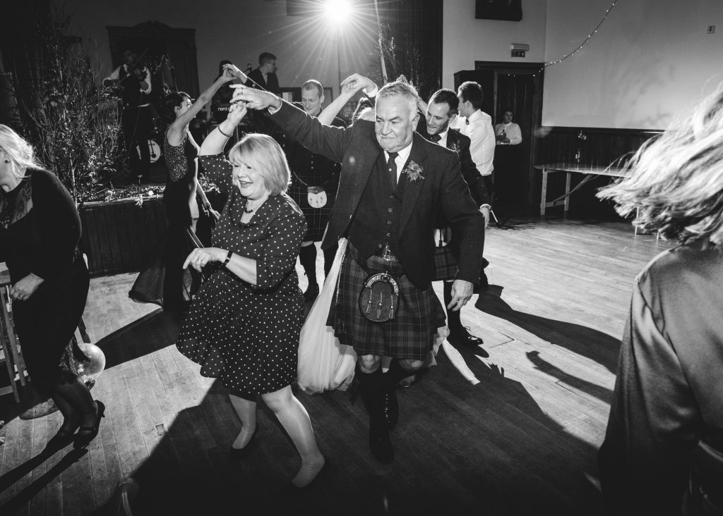 Couple twirling during wedding dances at Portree Village Hall wedding reception