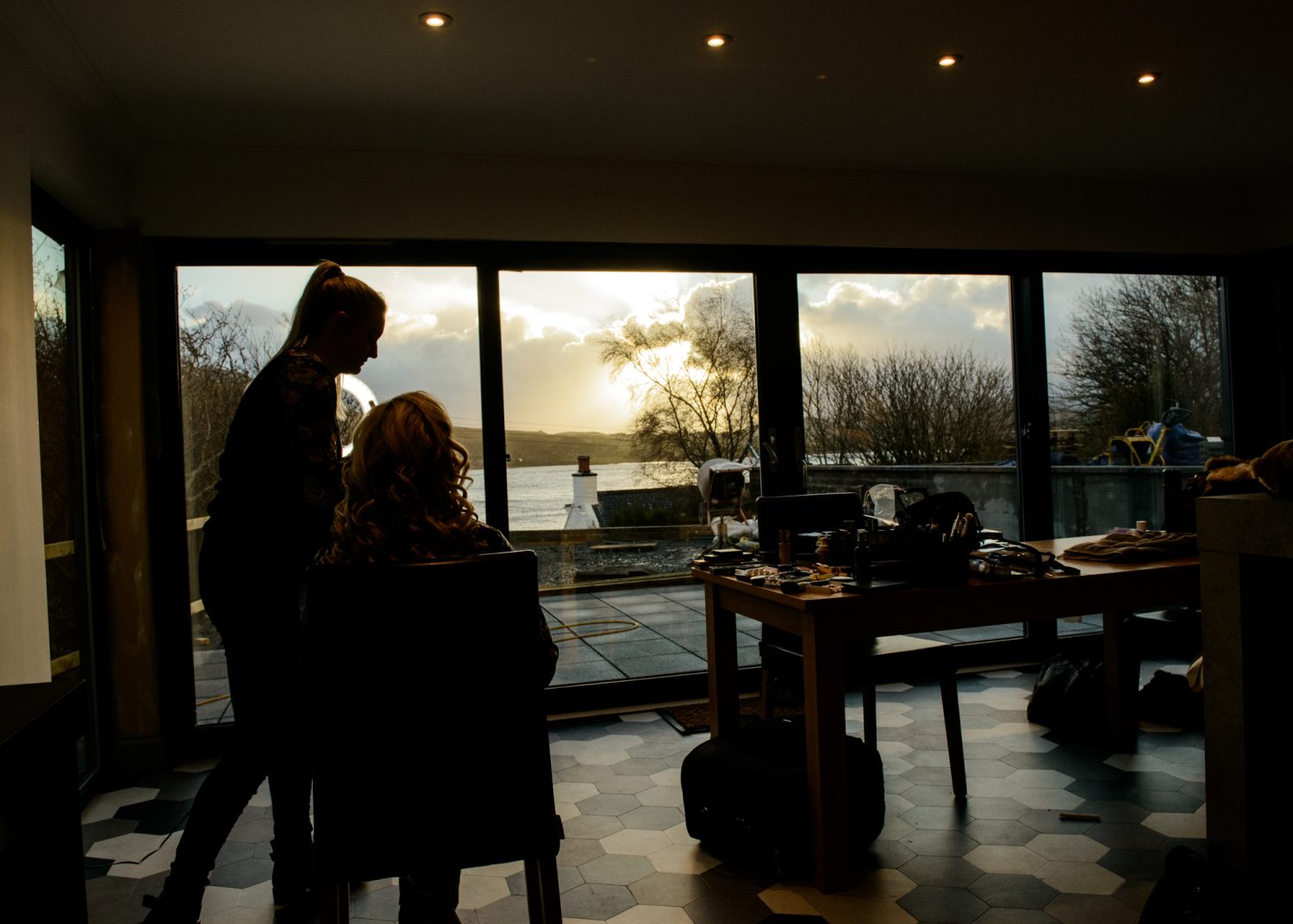 Bride having her wedding preparations at a window