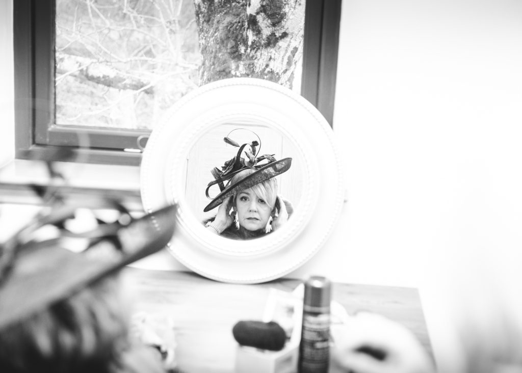 Mother of the bride having putting on her hat